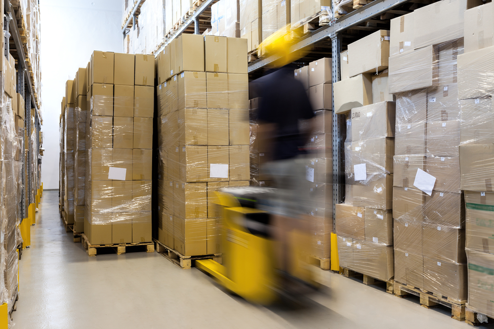 Fork lift with operator working in warehouse Fork lift with operator working in warehouse